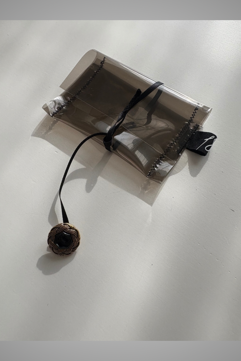 clear supersmall case with ribbon and button