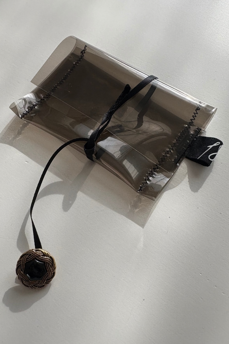 clear supersmall case with ribbon and button